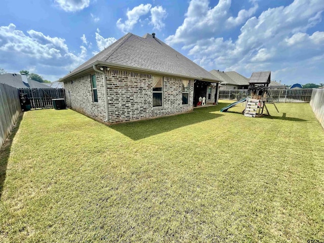 909 Charlie, Whitehouse, TX 75791 - rear view of house with a playground, brick siding, a shingled roof, and central AC unit