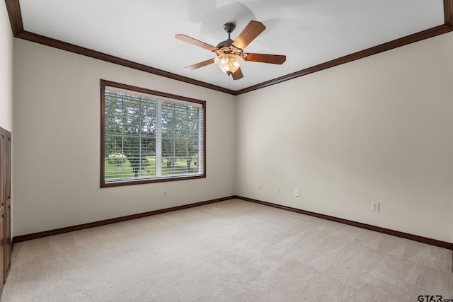 carpeted empty room featuring ceiling fan and ornamental molding