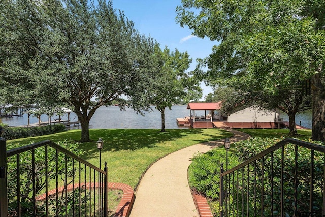 view of home's community featuring a yard and a water view