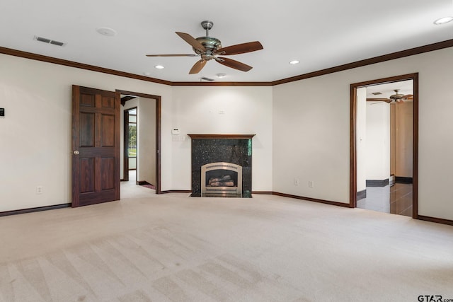 unfurnished living room with light carpet, crown molding, and ceiling fan