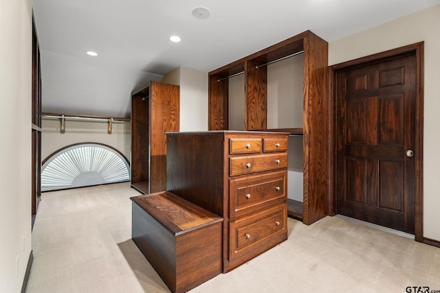 walk in closet featuring light carpet