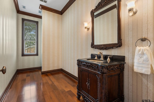 bathroom with vanity, wood-type flooring, and ornamental molding