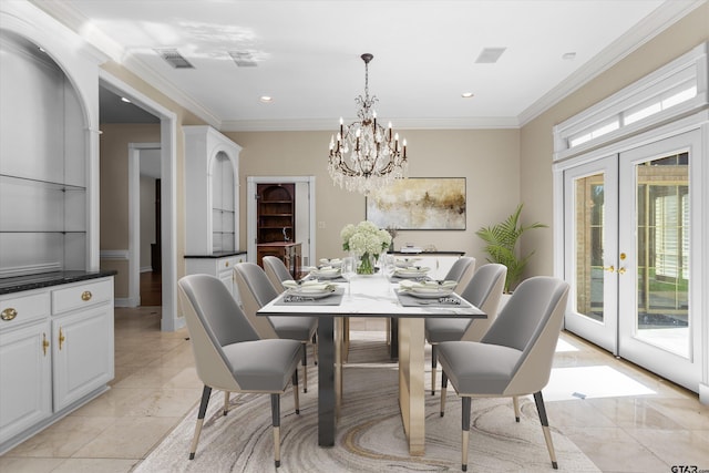 dining area featuring a chandelier, french doors, and crown molding