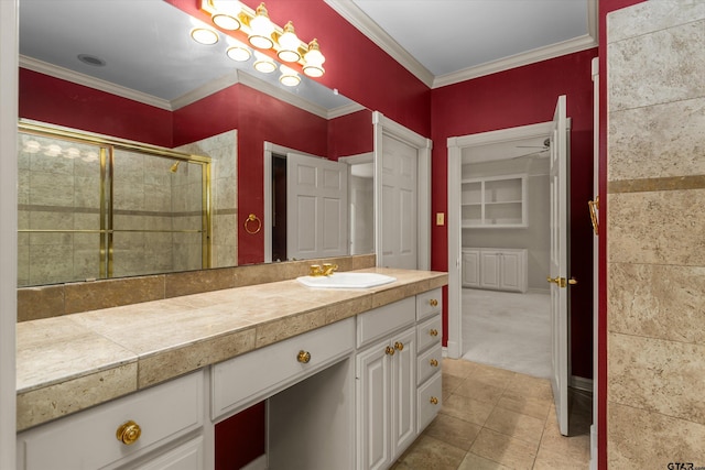 bathroom featuring tile patterned flooring, vanity, an enclosed shower, and ornamental molding