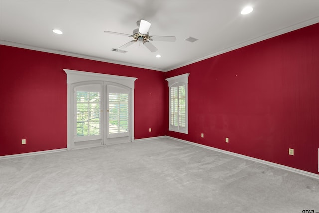 carpeted empty room with ceiling fan and ornamental molding