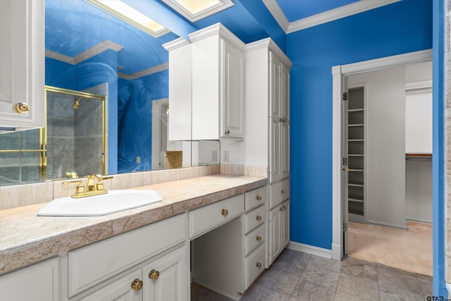 bathroom featuring crown molding, vanity, and a shower with shower door