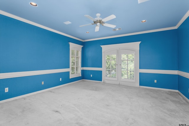 carpeted empty room with ceiling fan and ornamental molding