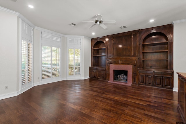 unfurnished living room featuring crown molding, ceiling fan, and dark wood-type flooring