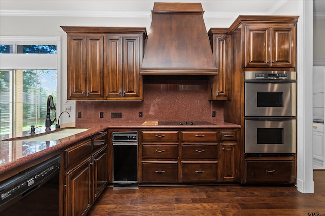 kitchen with sink, light stone counters, dark hardwood / wood-style floors, black appliances, and custom exhaust hood