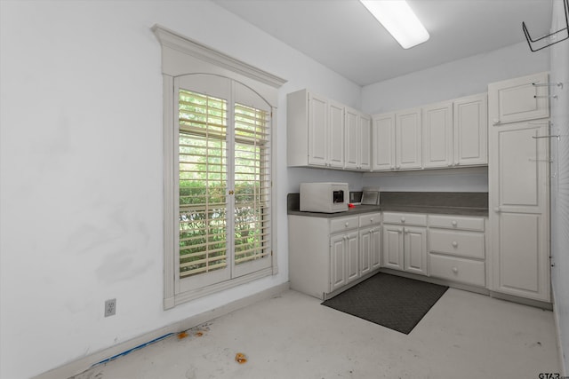 kitchen featuring white cabinetry and plenty of natural light