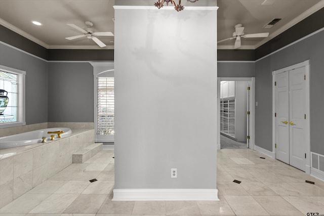 bathroom with tile patterned floors, ornamental molding, and tiled tub