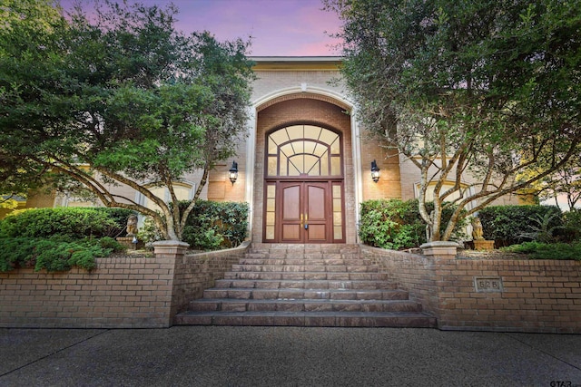 view of exterior entry at dusk