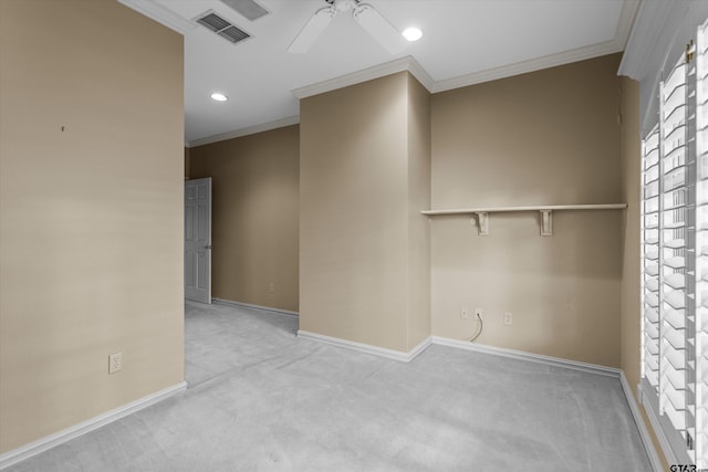 carpeted spare room featuring ceiling fan and crown molding