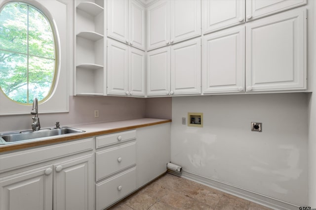 clothes washing area with electric dryer hookup, cabinets, sink, and hookup for a washing machine