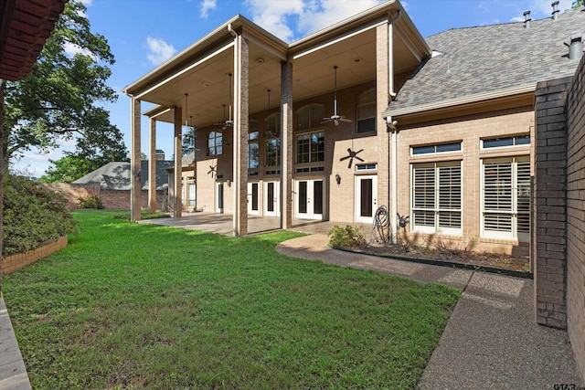 back of property with french doors, a yard, ceiling fan, and a patio area