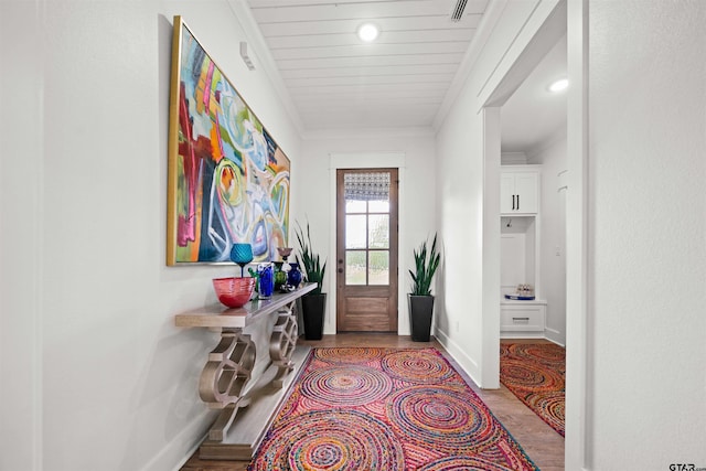 doorway to outside with light wood-type flooring and ornamental molding