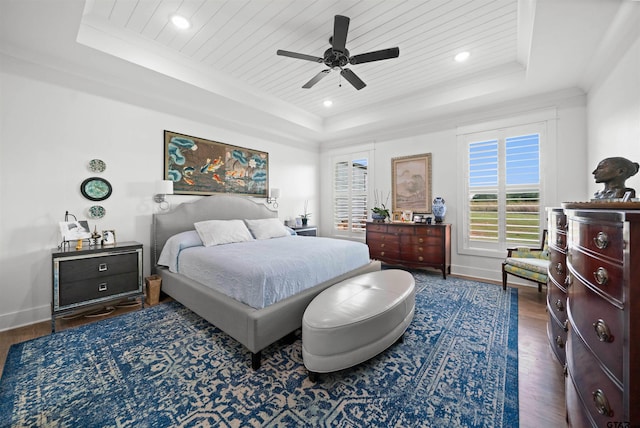 bedroom featuring ceiling fan, dark hardwood / wood-style floors, wood ceiling, and a tray ceiling