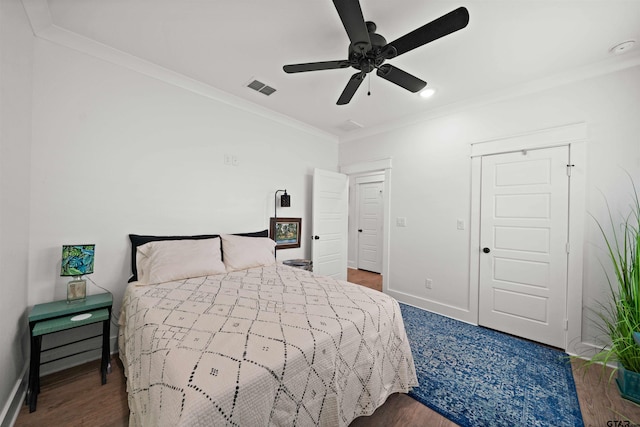 bedroom with hardwood / wood-style flooring, ceiling fan, and crown molding