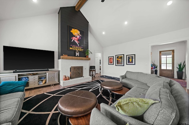 living room featuring a fireplace, hardwood / wood-style flooring, beam ceiling, and high vaulted ceiling