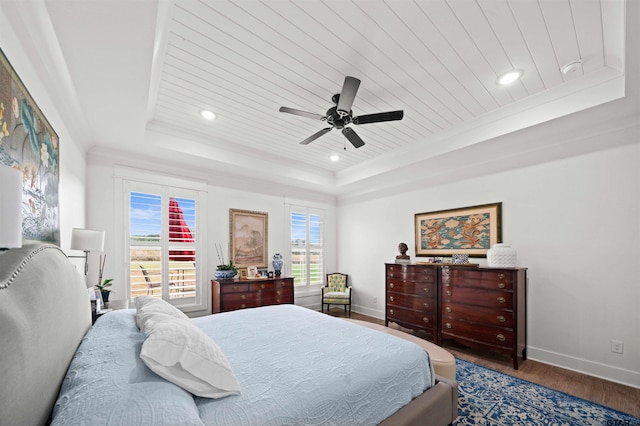 bedroom featuring a tray ceiling, hardwood / wood-style floors, wooden ceiling, and ceiling fan