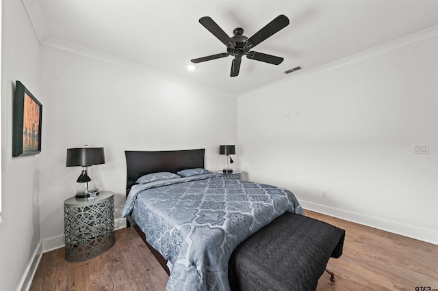 bedroom featuring ornamental molding, hardwood / wood-style flooring, and ceiling fan