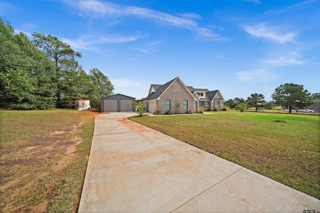 view of front of home with a garage, a front lawn, and a shed