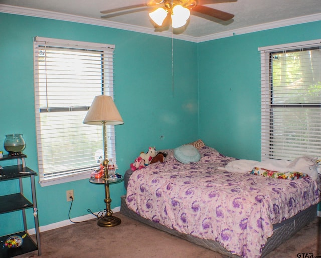 carpeted bedroom with ornamental molding and ceiling fan