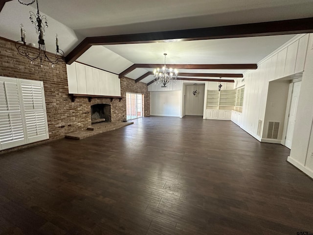 unfurnished living room featuring dark hardwood / wood-style flooring, vaulted ceiling with beams, a notable chandelier, a fireplace, and brick wall