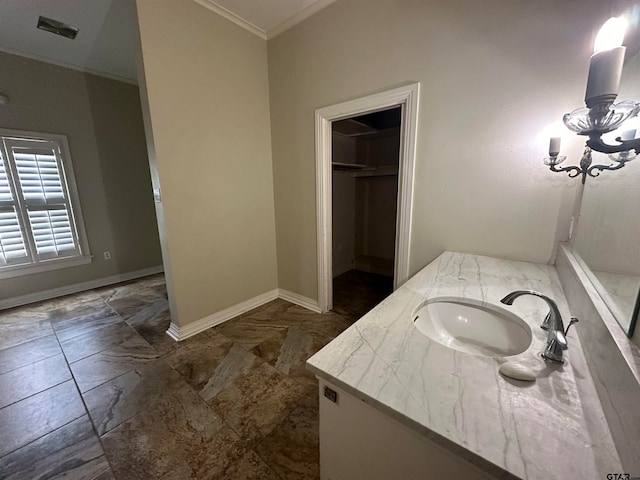 bathroom with vanity, an inviting chandelier, and ornamental molding