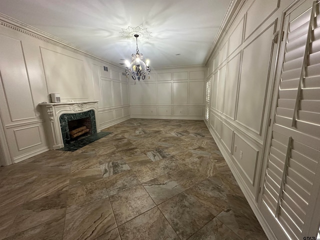 unfurnished living room with an inviting chandelier, ornamental molding, and a fireplace