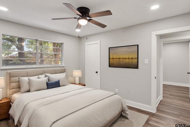 bedroom with hardwood / wood-style flooring and ceiling fan