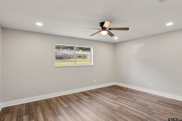 empty room with ceiling fan and hardwood / wood-style floors