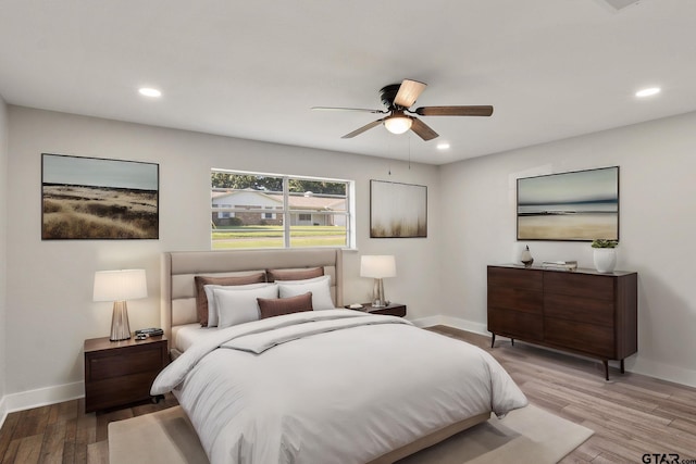 bedroom with ceiling fan and light wood-type flooring