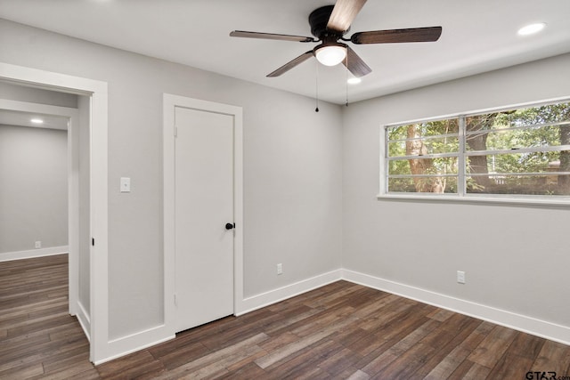 unfurnished bedroom with ceiling fan and dark hardwood / wood-style flooring