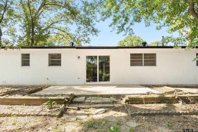 rear view of property featuring a patio area