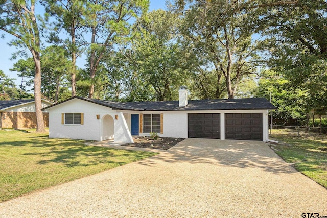 single story home featuring a garage and a front yard