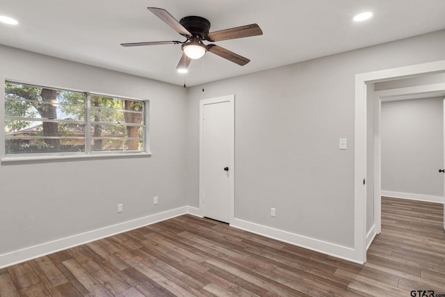 unfurnished room featuring dark hardwood / wood-style flooring and ceiling fan