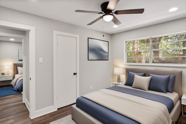 bedroom featuring dark hardwood / wood-style floors and ceiling fan