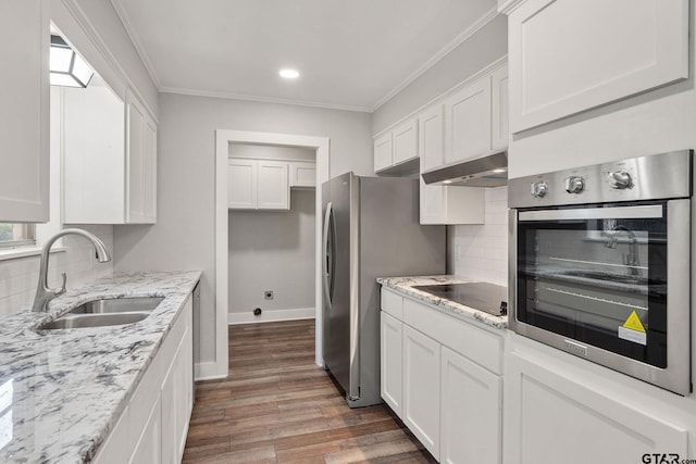 kitchen with sink, crown molding, dark hardwood / wood-style floors, stainless steel appliances, and white cabinets