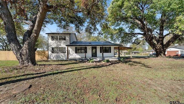 view of front of property with a front yard and a carport