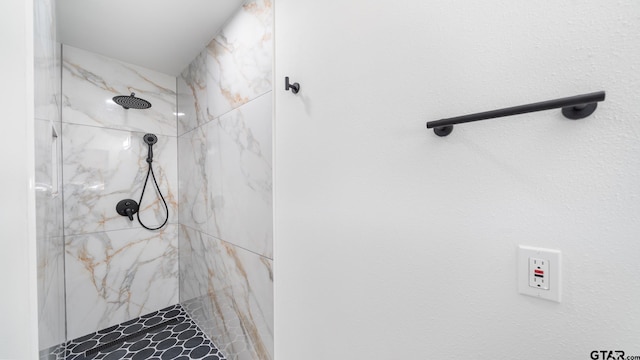 bathroom with tiled shower