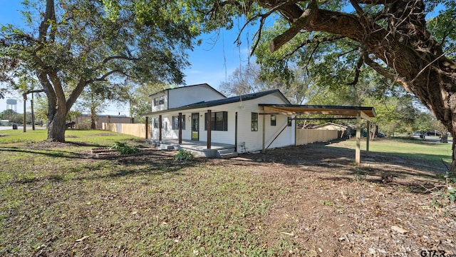 view of side of property with a lawn and a carport