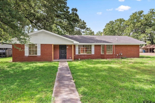 2002 Friendly Ave, Mount Pleasant, TX 75455 - ranch-style house with a front yard and brick siding
