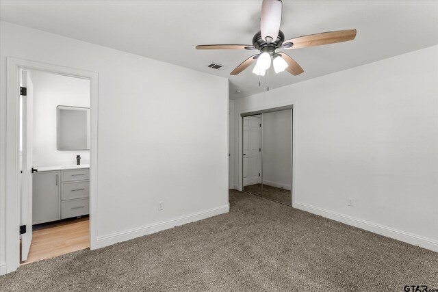 2002 Friendly Ave, Mount Pleasant, TX 75455 - unfurnished bedroom with light colored carpet, baseboards, a sink, and ensuite bathroom