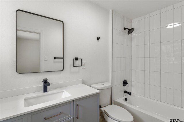 2002 Friendly Ave, Mount Pleasant, TX 75455 - full bath featuring toilet, vanity, and washtub / shower combination