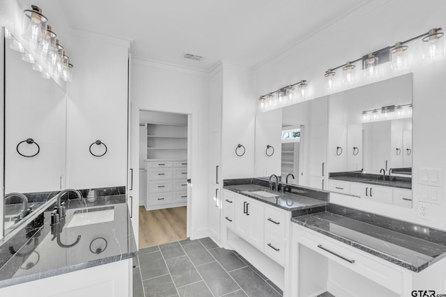 bathroom with tile patterned floors, vanity, and ornamental molding