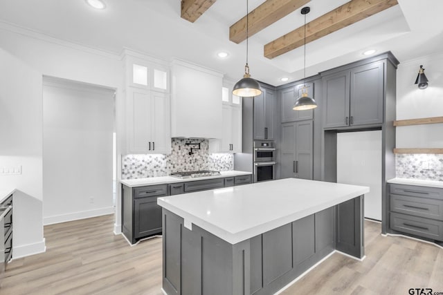 kitchen with light hardwood / wood-style floors, gray cabinets, stainless steel appliances, and beamed ceiling