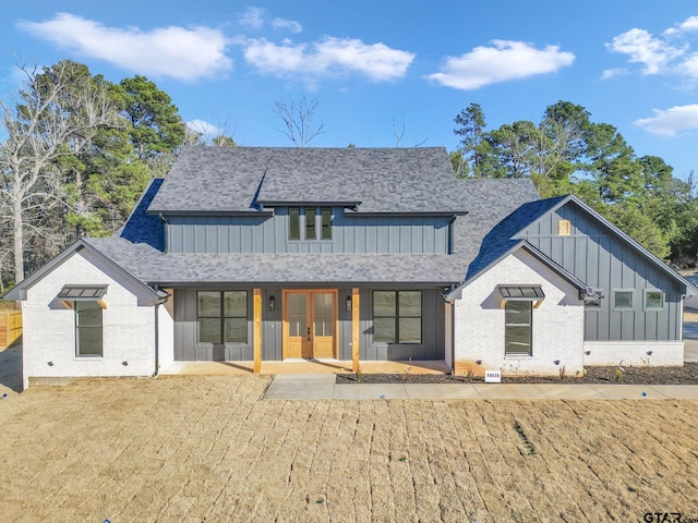 back of house with a yard, french doors, and a patio