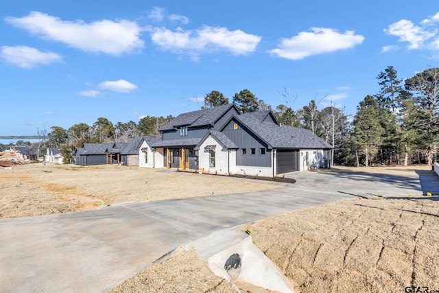 modern inspired farmhouse with a garage