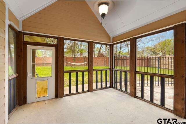 803 Marquette Ln, Tyler, TX 75703 - unfurnished sunroom featuring vaulted ceiling, healthy amount of natural light, and a ceiling fan